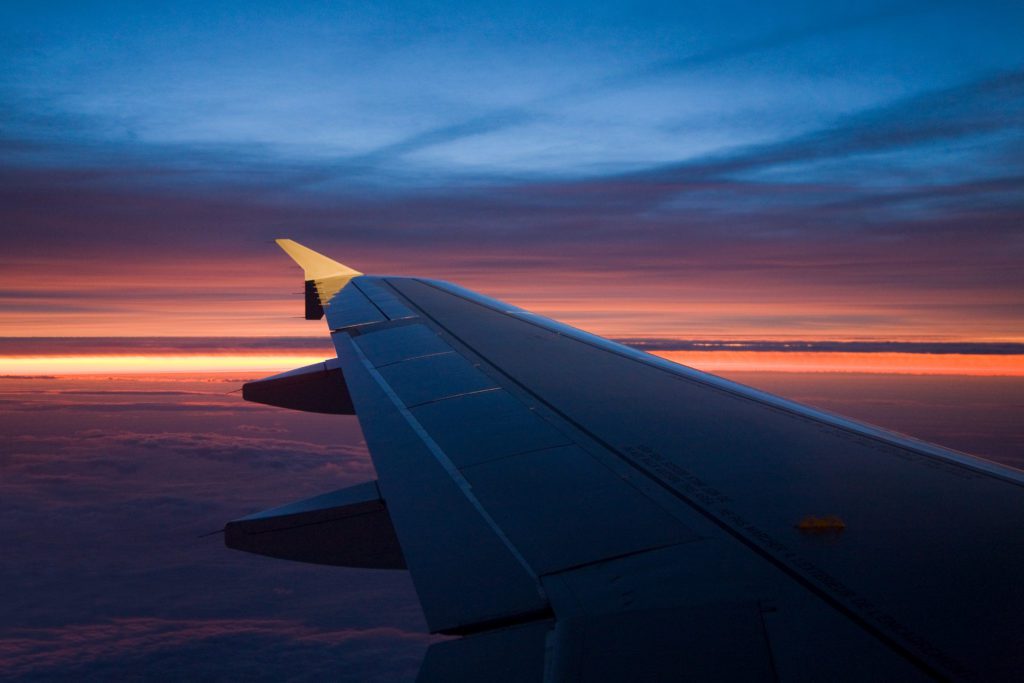 Airplane wing at sunset