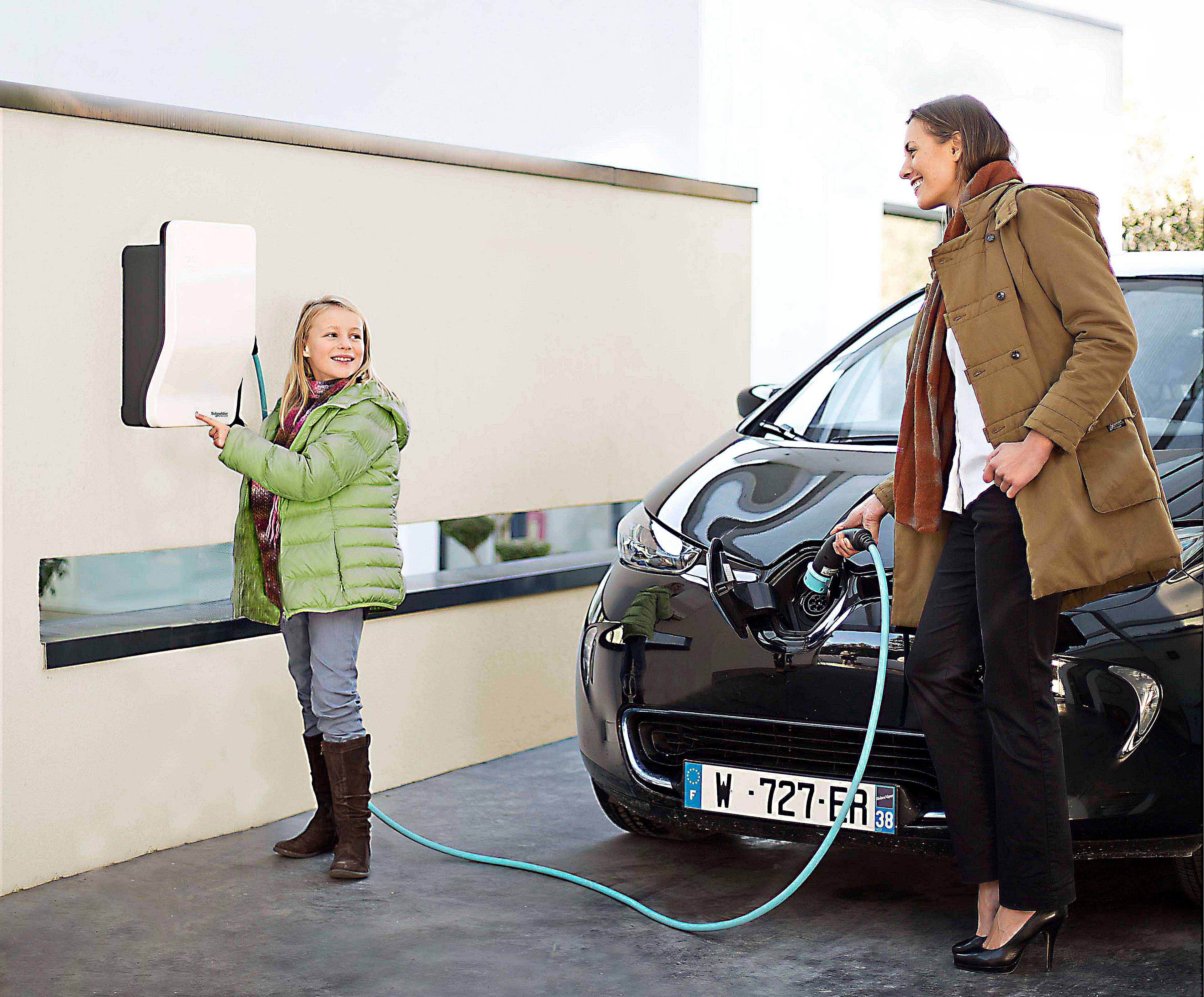 Mother and daughter using residential EV charging