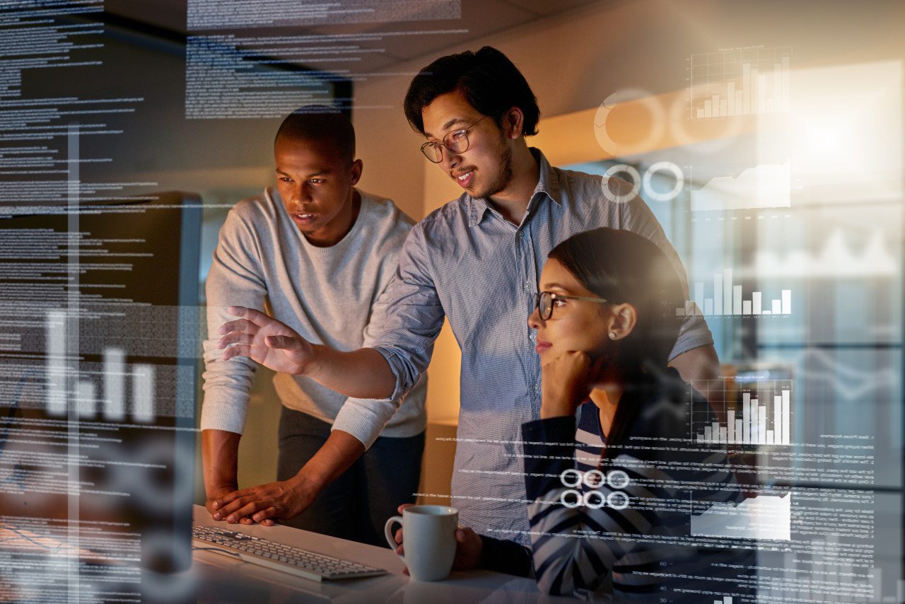 Shot of computer programmers looking through data in the office