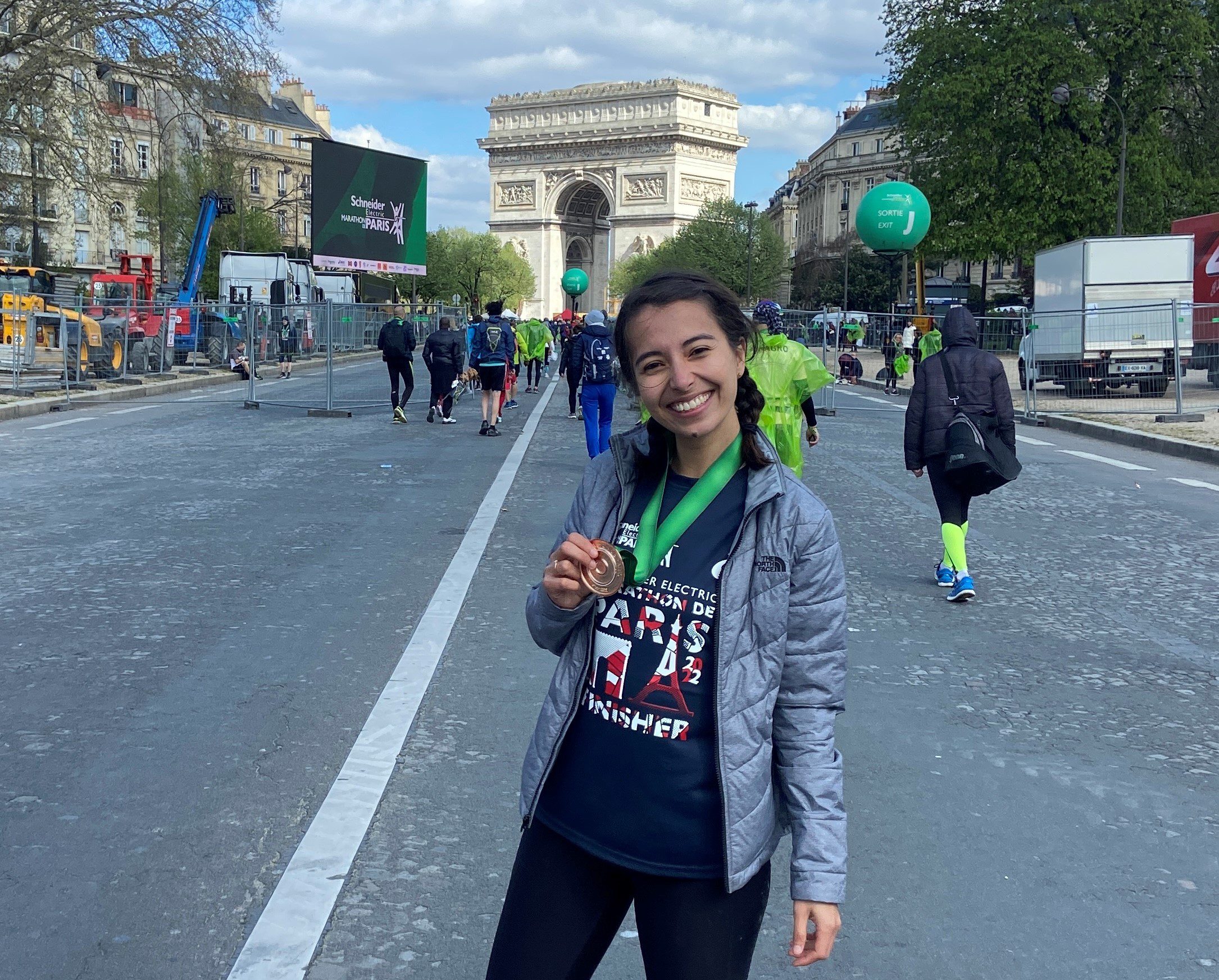 Schneider Electric employee Roxann West at the Paris Marathon holding her medal.