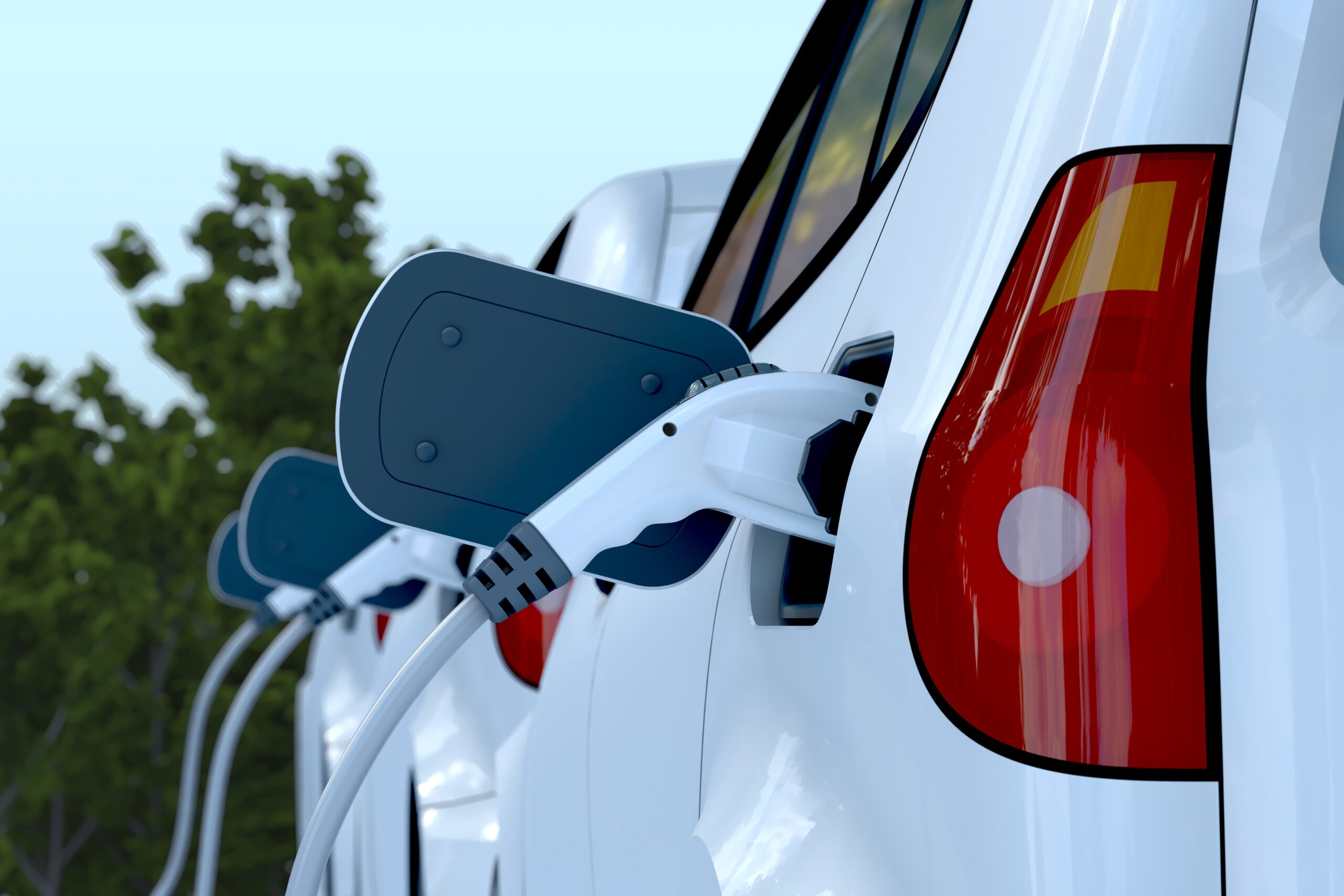 A line of white cars, charging at an Electric Vehicle charging station