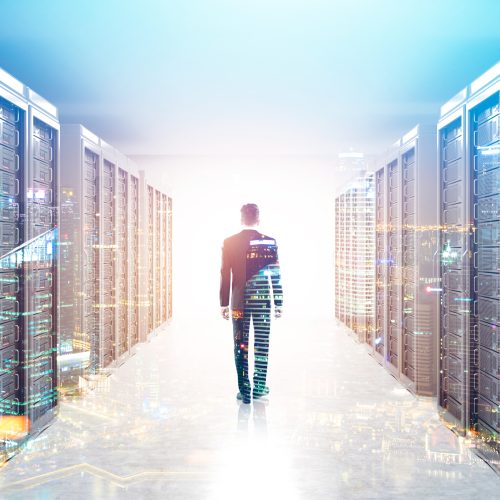 Man walking in a futuristic data center representing the evolution of Modern DCIM as Force for More Resilient, Secure, and Sustainable IT