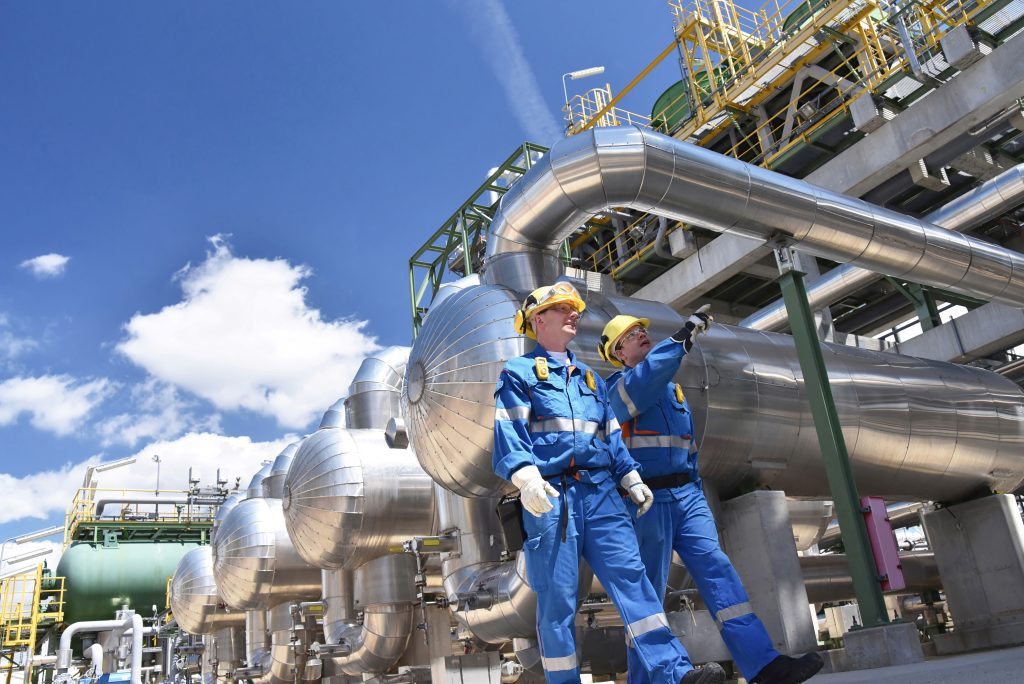 Two engineers review process safety protocols at a chemical plant