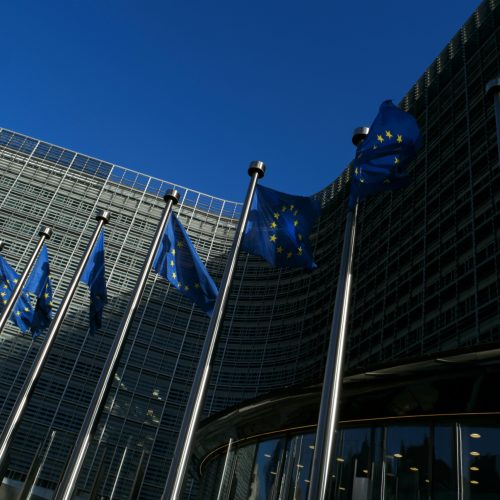 European Union flags waving at Berlaymont building of the European Commission representing a more resilient Europe.