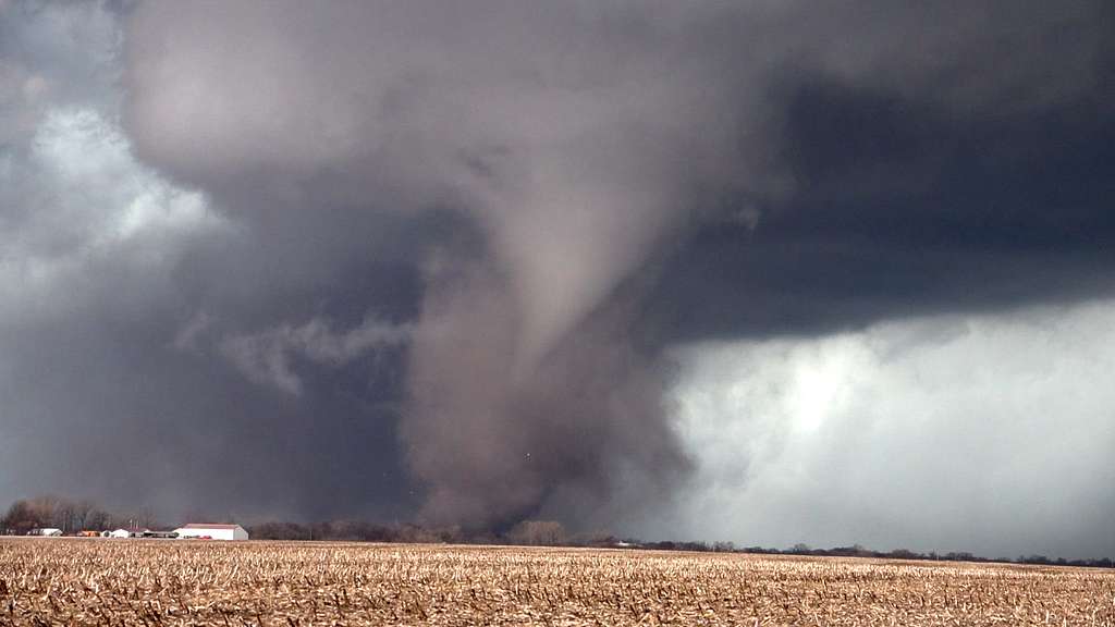 A photo of a tornado in a farm field demonstrating the impact of powerful storms illustrating the movie Twister and climate change