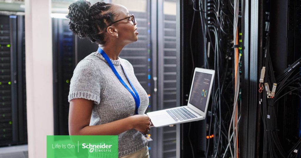 Woman in data center using EcoStruxure IT Secure NMC System. 