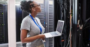 Woman in data center using EcoStruxure IT Secure NMC System.