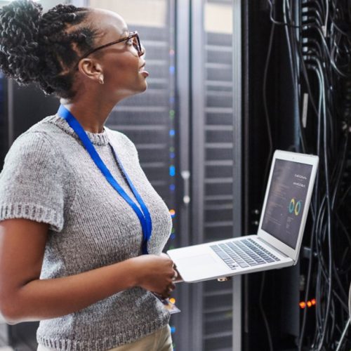 Woman in data center using EcoStruxure IT Secure NMC System.