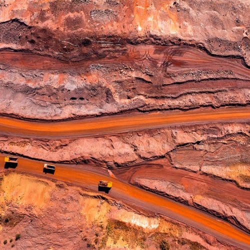 Aerial view of open pit iron ore and heavy mining equipment.