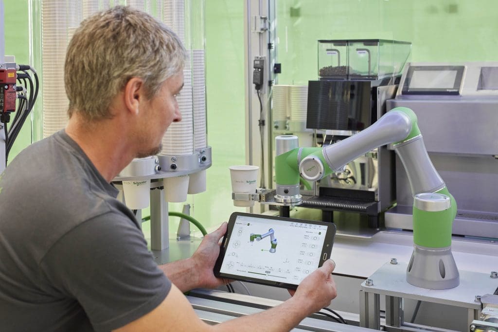 an engineering using smart operations with a robotic arm at a factory where information is predominantly digital