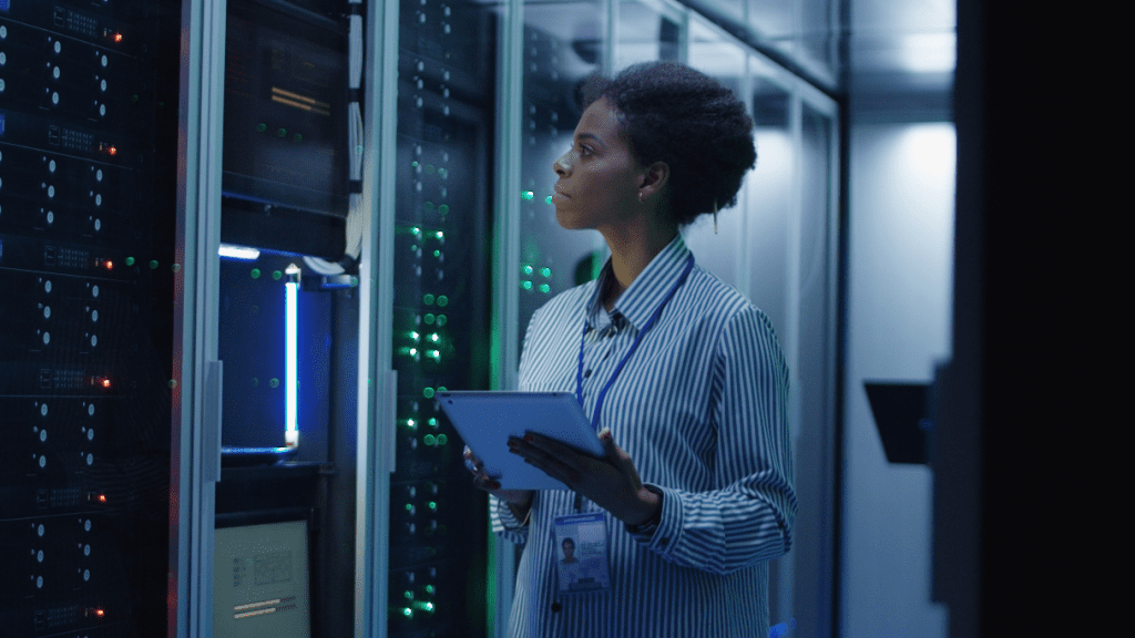 Woman working in a data center holding a tablet.