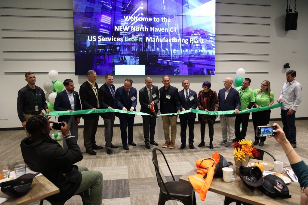 Schneider Electric execs and local politicians participate in a ribbon cutting at the new North Haven EcoFit Facility.