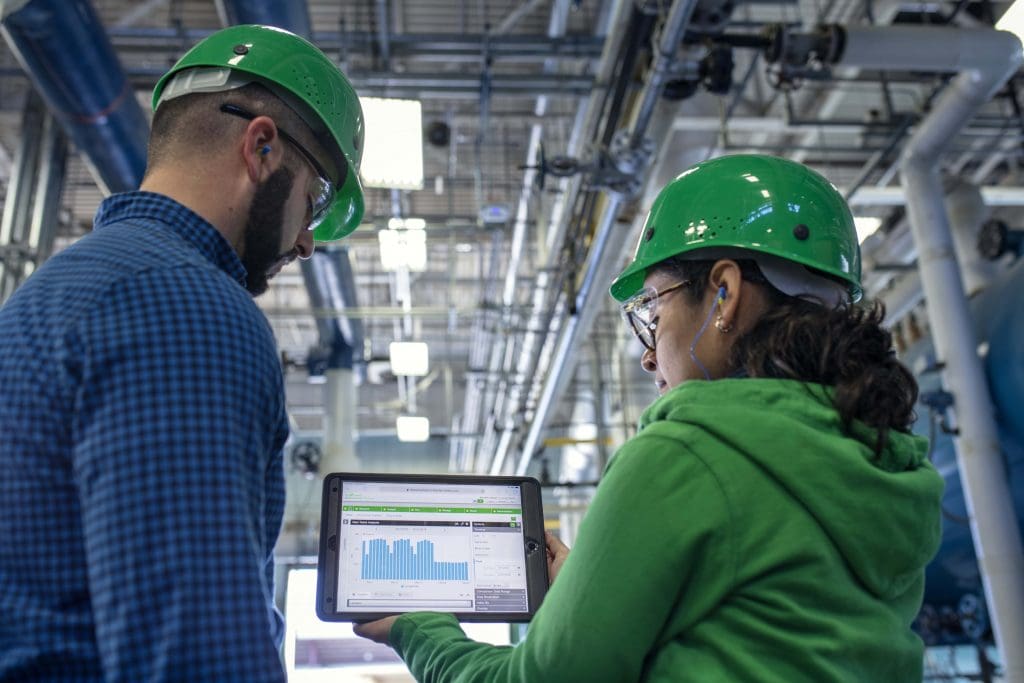 a couple of engineers using smart operations at a factory where information is predominantly digital