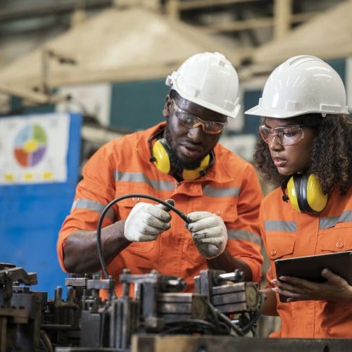 Alignment and assembly jigs developed to boost quality and efficiency in an auto parts manufacturing Industry. Two African American Process Engineers discussions on assembly jig and verify the dimensional accuracy of the fixture to increase durability for support in a production process of condition-based maintenance.