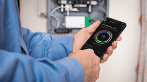 Person holding phone with Schneider Home app