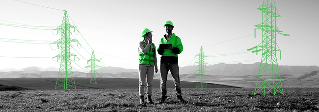 Two Individuals in a filed Next to Electric Towers
