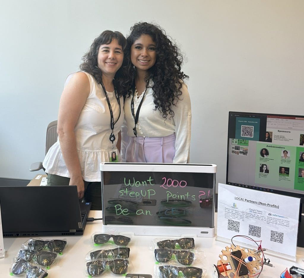 Promoting purpose: Mirna and Ariana highlight volunteer opportunities at a company event.