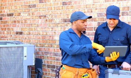 Two electricians talking outside.