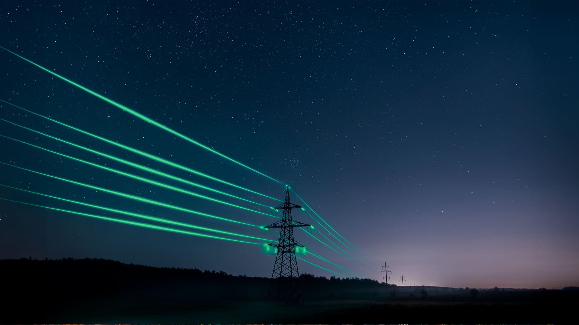 High-voltage transmission tower illuminated with green light beams under a starry night sky, symbolizing the connection between AI and the power grid.