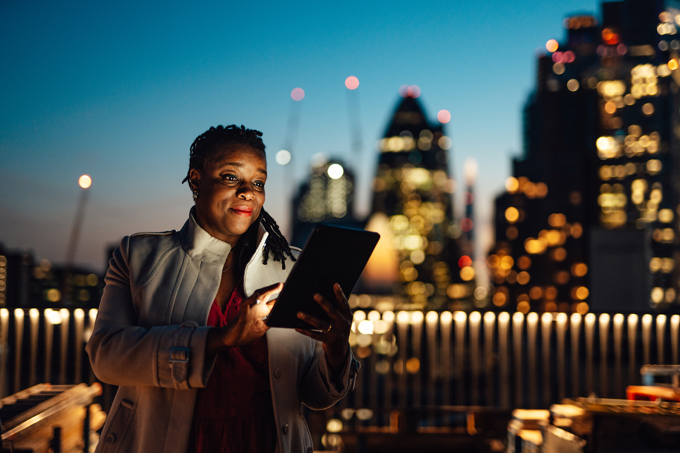 Financial professional using a tablet in an urban setting